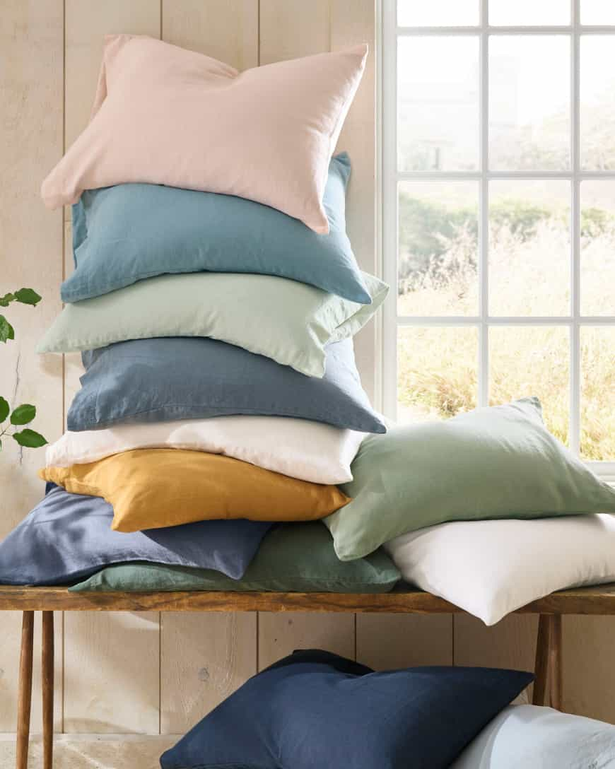 A stack of percale sheets in many solid colors and prints. Shop sheets.